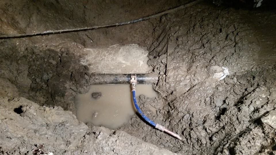 Repaired water main pipe in an excavated trench